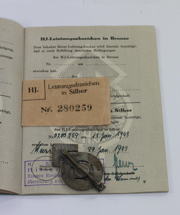  Hitlerjugen (HJ), Leistungsabzeichen in Silber, Hst. RZM M1/35, in Verleihungstüte mit Leistungsbuch, alles nummerngleich (!) - Militaria-Berlin