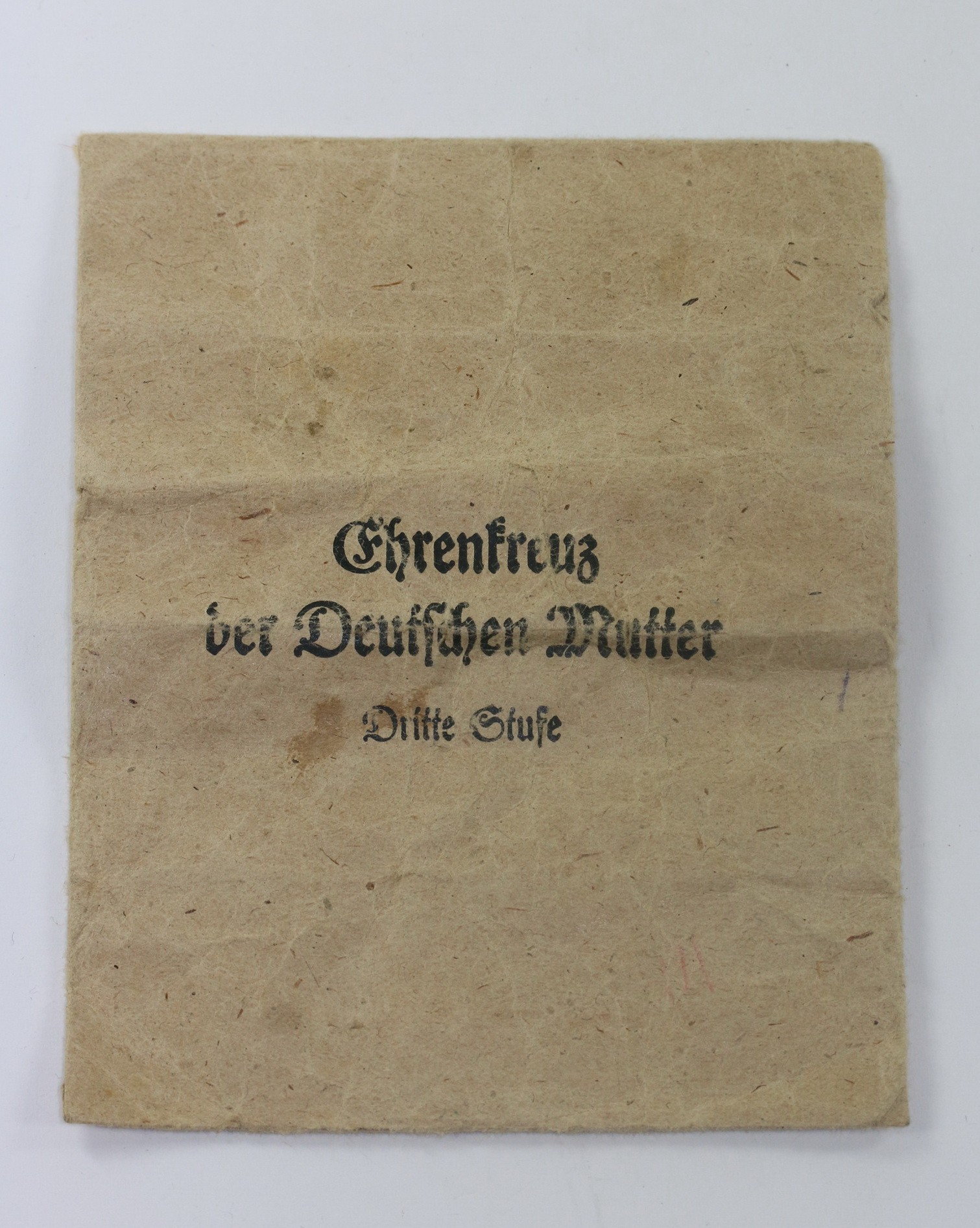 Verleihungstüte Mutterkreuz in Bronze (3. Stufe), Frank & Reif, Stuttgart – Bild 1